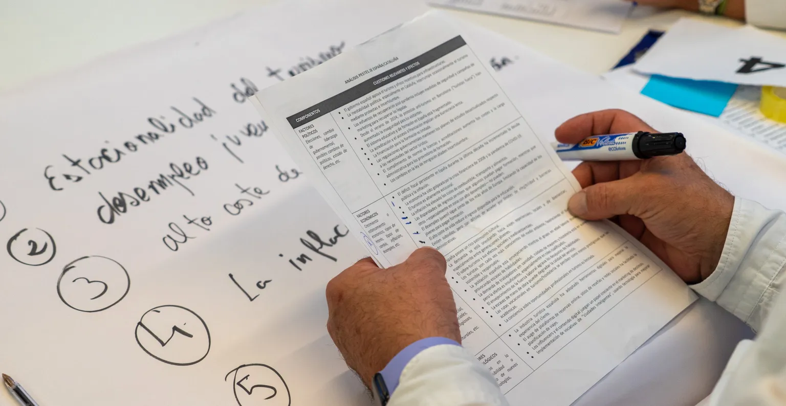 Imagen de un integrante del workshop escribiendo sobre un papel